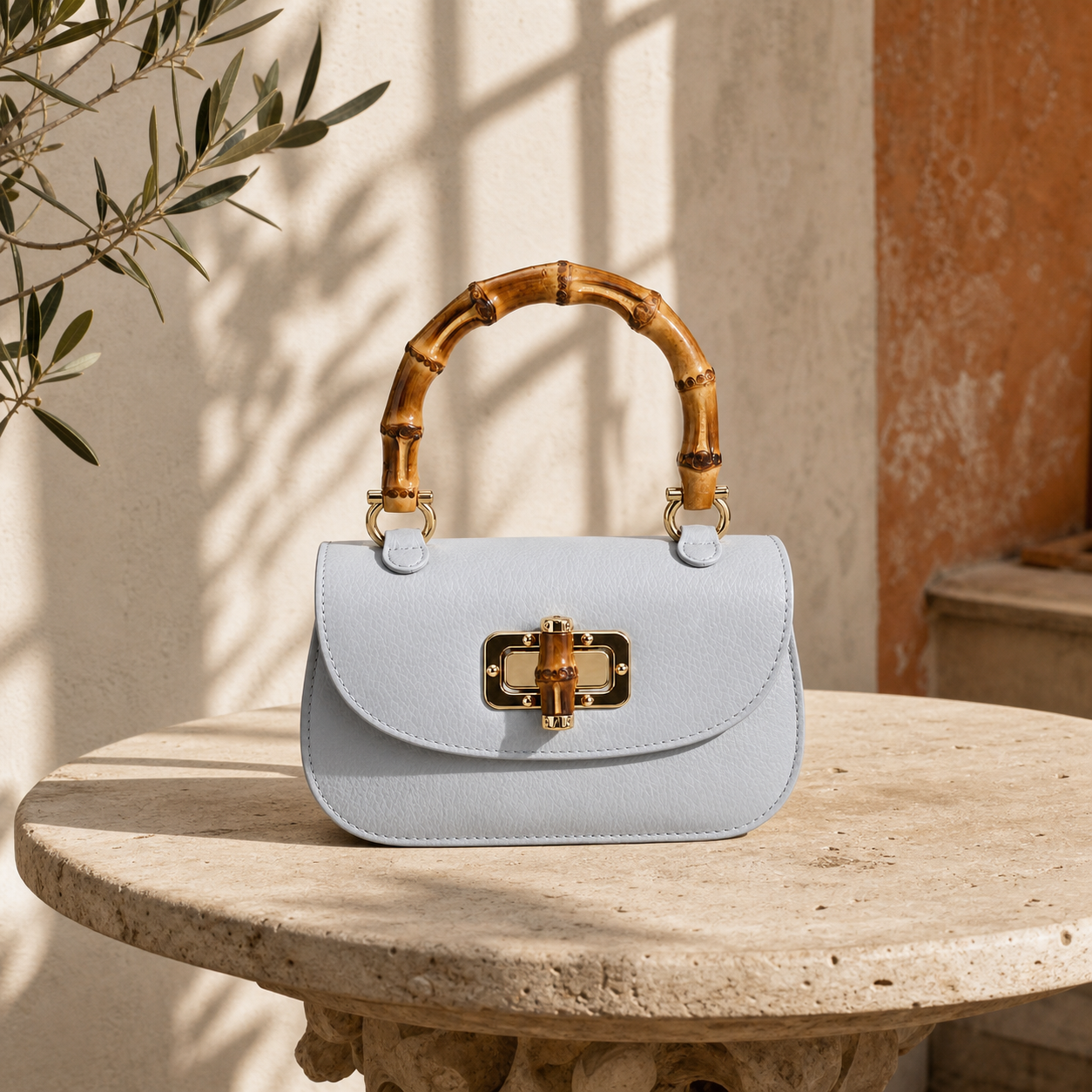 The Pitti Mini photographed in a sunlit Tuscan courtyard